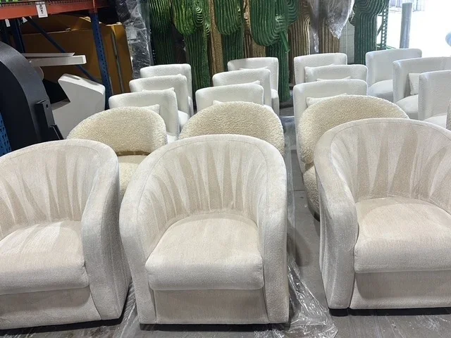 Rows of cream upholstered tub chairs staged for cleaning