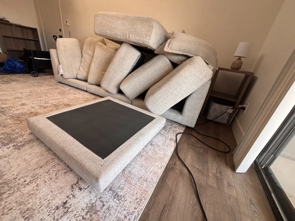 Sofa with every cushion removed and stood on end during cleaning